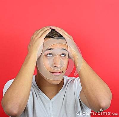 Portrait of desperate man against red background