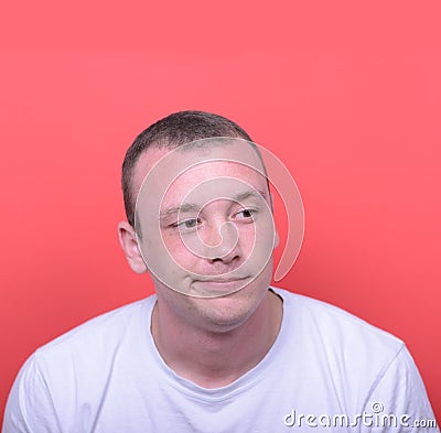 Portrait of desperate man against red background