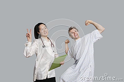 Portrait of doctor gesturing peace sign with patient cheering up