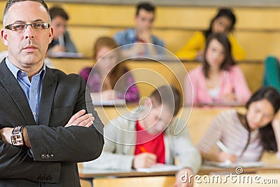 Portrait of an elegant teacher with students at lecture hall