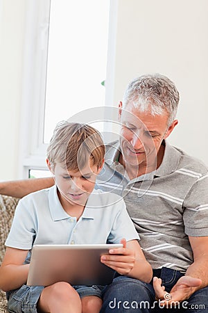 Portrait of a father and his son using a tablet computer