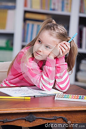 Portrait of girl drawing with colorful pencils