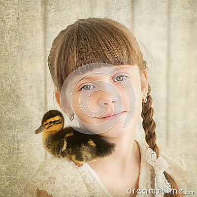Portrait of girl with duckling on shoulder
