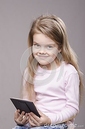 Portrait girl with a small mirror in hands of