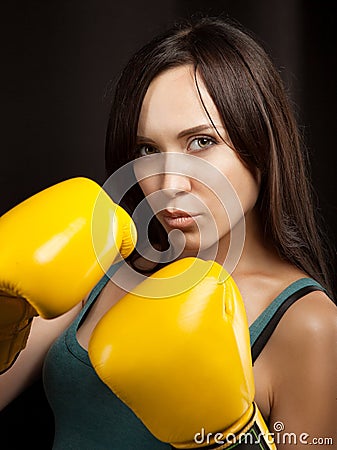 Portrait of a girl in yellow boxing gloves