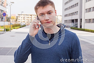Portrait of handsome man in urban background talking on phone.