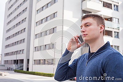 Portrait of handsome man in urban background talking on phone.