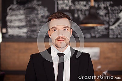 Portrait of handsome stylish man in elegant black suit.