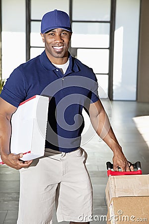 Portrait of a happy African American man carrying delivery boxes
