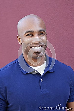 Portrait of a happy bald African American male over colored background