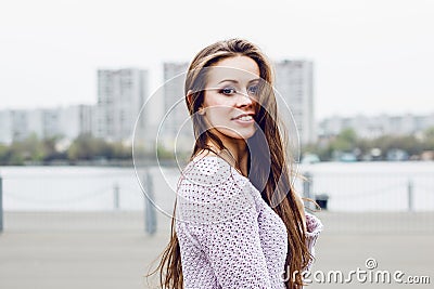 Portrait of happy beautiful smiling woman on urban background