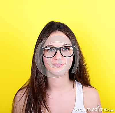 Portrait of happy casual woman with glasses against yellow backg