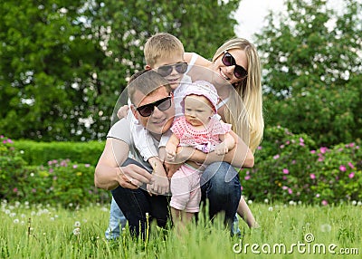 Portrait Of Happy Family In Garden