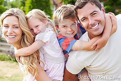 Portrait Of Happy Family In Garden