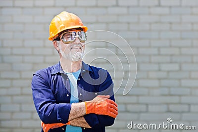 Portrait of happy seniorman with hard hat Posing with crossed ar