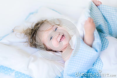 Portrait of a happy toddler waking up in the morning