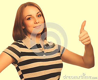 Portrait happy woman young girl shows positive sign thumbs yes,