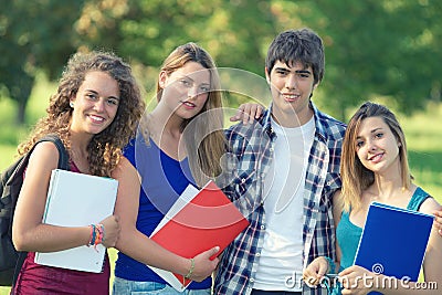 Portrait happy young students in park