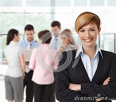 Portrait if happy businesswoman with colleagues