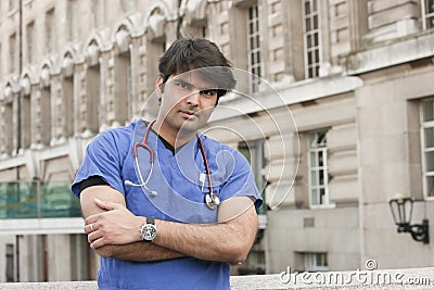 Portrait of an Indian male doctor standing with arms crossed