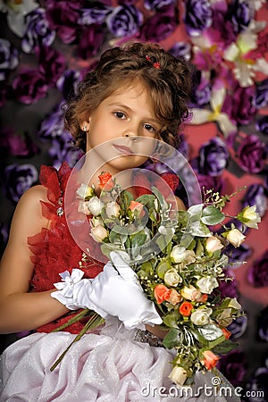 Portrait of little girl in dress with flower