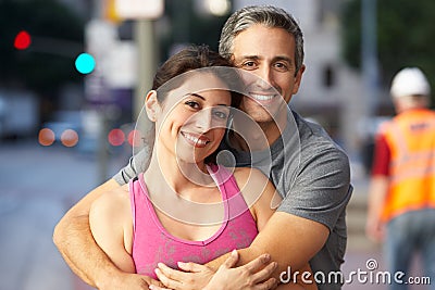 Portrait Of Male And Female Runners On Urban Street