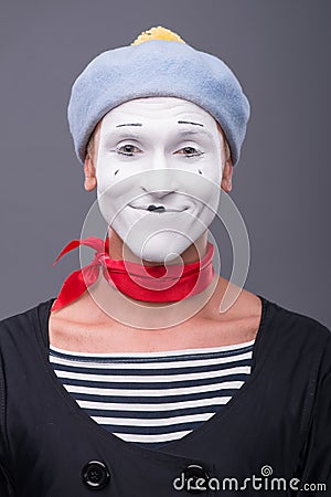Portrait of male mime with grey hat and white face