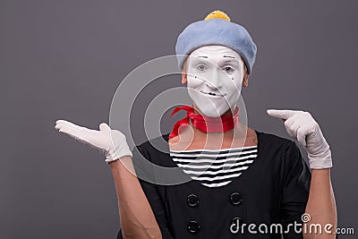 Portrait of male mime with grey hat and white face