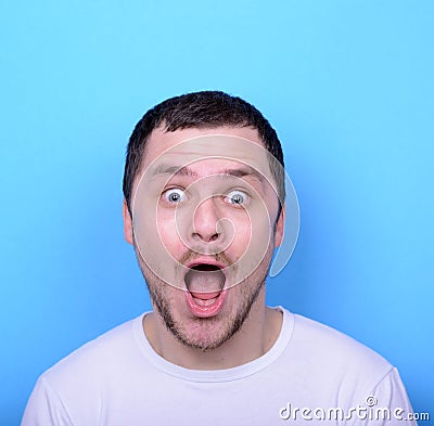 Portrait of man with funny face against blue background