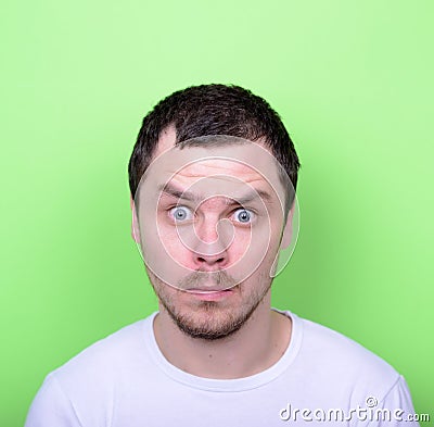 Portrait of man with funny face against green background