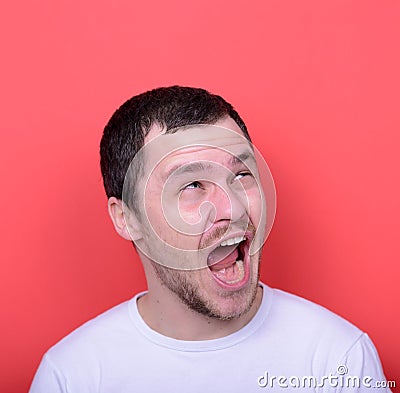Portrait of man with funny face against red background