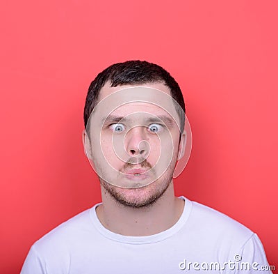 Portrait of man with funny face against red background