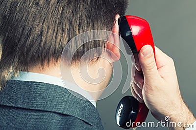 Portrait of a man speaking phone isolated on gray