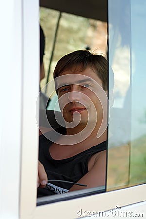 Portrait of the man through the window of the