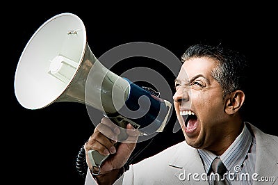 Portrait of manager shouting in loud speaker