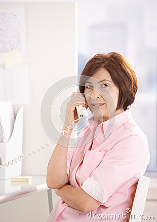 Portrait of mature office worker on phone call