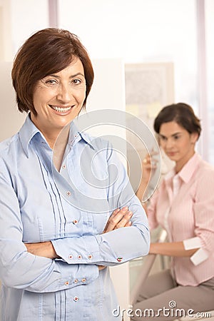 Portrait of mature office worker smiling at camera