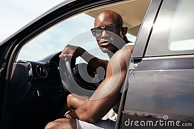 Portrait of muscular young man in car