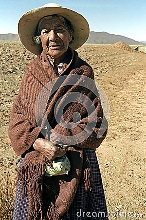 Portrait of old Indian woman with coca leaves