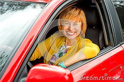 Portrait of older woman driving a car