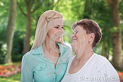 Portrait: older woman with her granddaughter or daughter in the