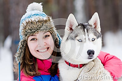 Portrait of a pretty young woman with her pet dog