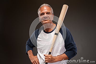 Portrait of a senior man posing with baseball bat