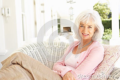 Portrait Of Senior Woman Relaxing In Chair