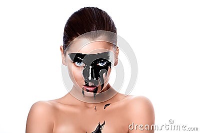 Portrait of sensual woman with black paint on face