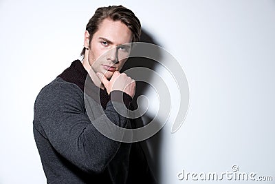 Portrait of sexy young man with hand near face.