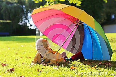 Portrait of small preschooler girl with colorful umbrella