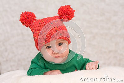 Portrait of smiling baby in red cap