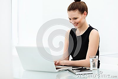 Portrait of smiling Business Woman with a laptop