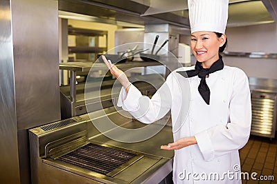Portrait of a smiling female cook in kitchen